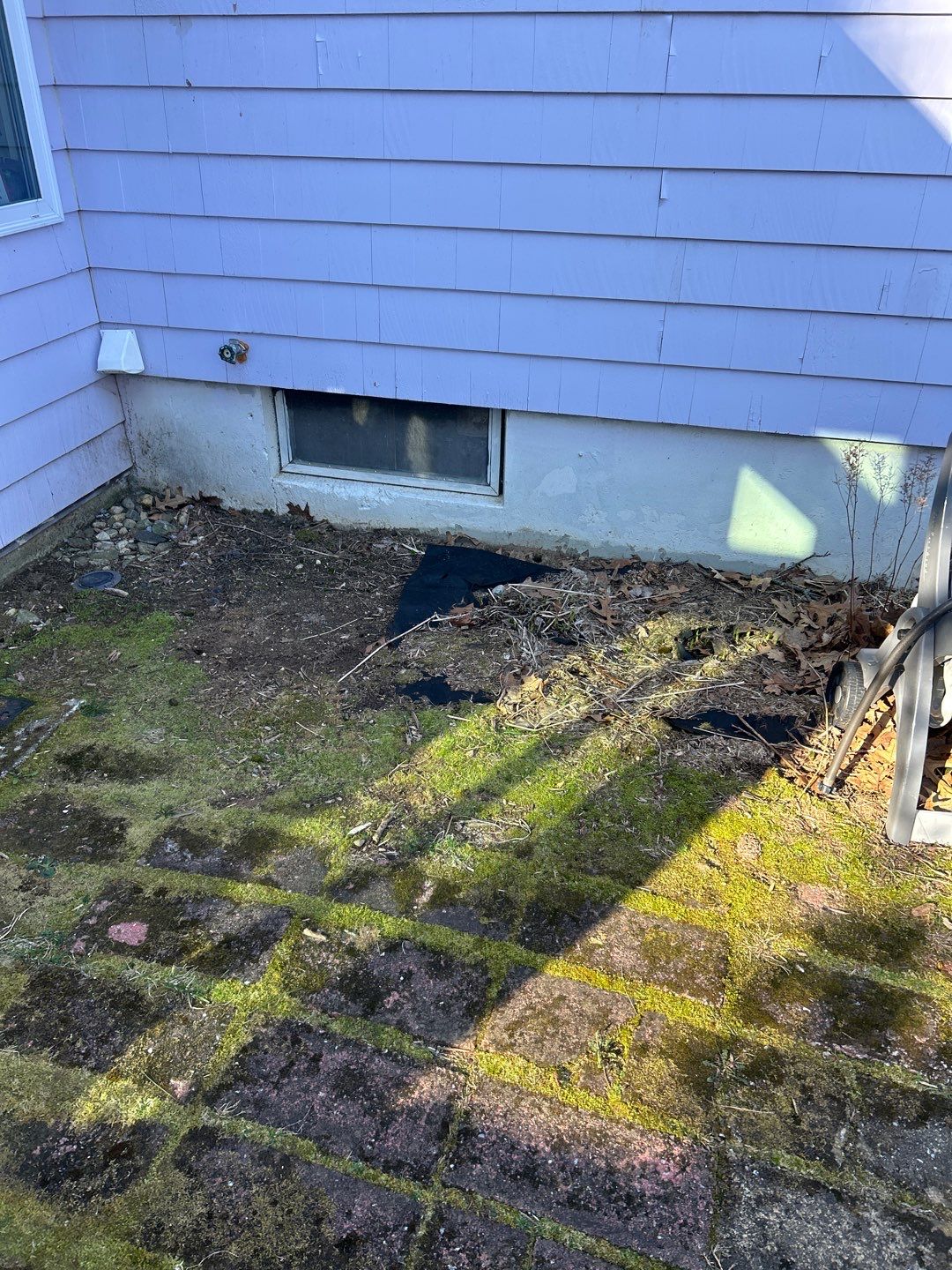 Before egress window installation in Lebanon, Connecticut — exterior view