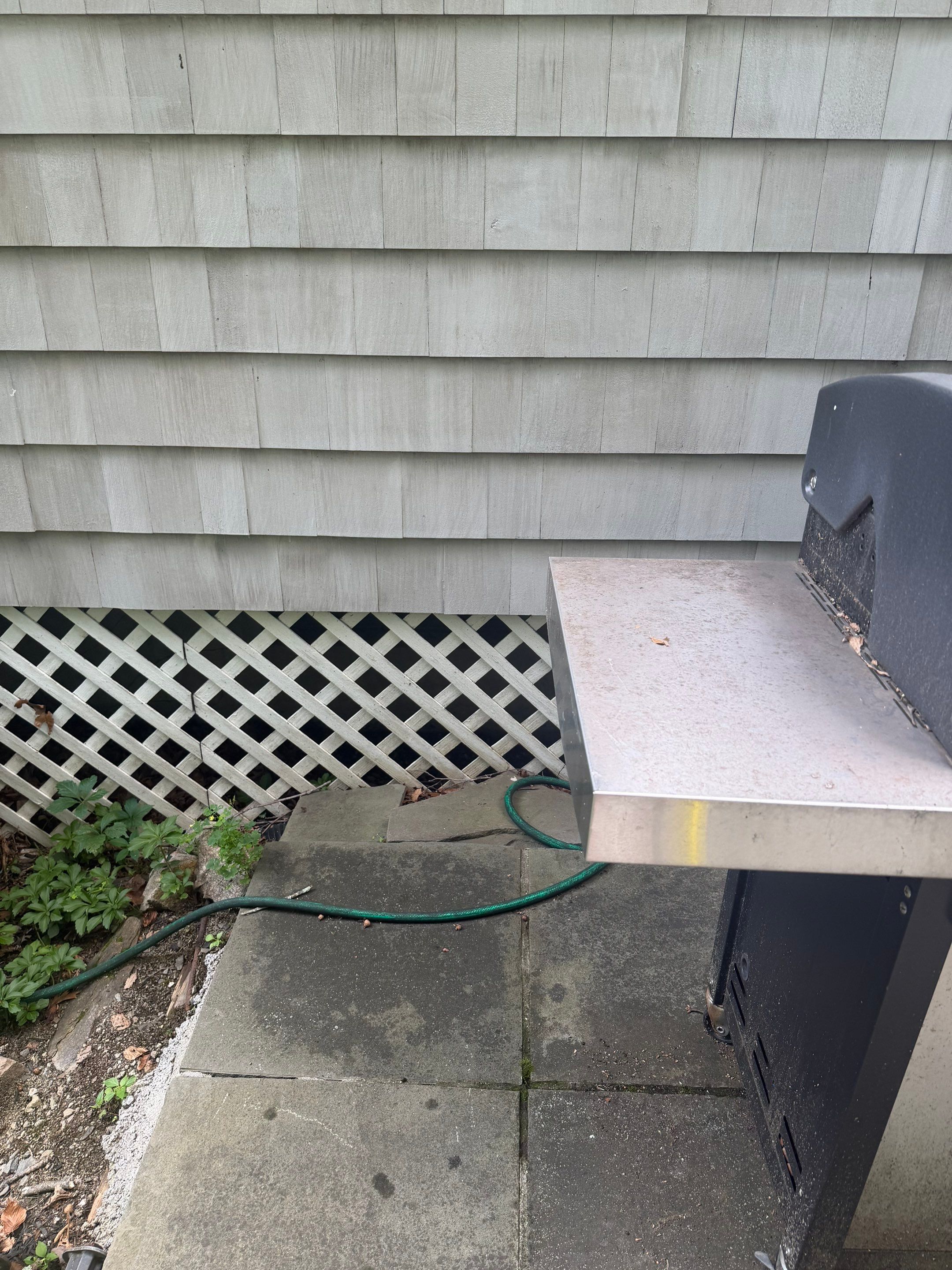 Before egress window installation in New Canaan, Connecticut — exterior view