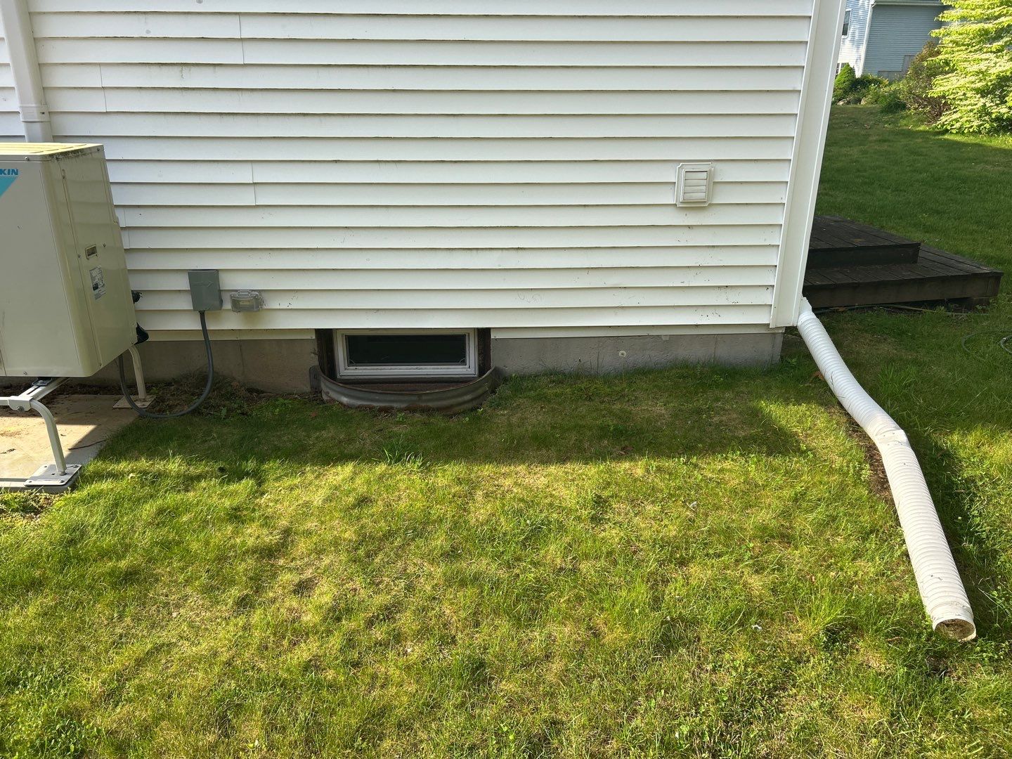 Before egress window installation in East Lyme, Connecticut — exterior view