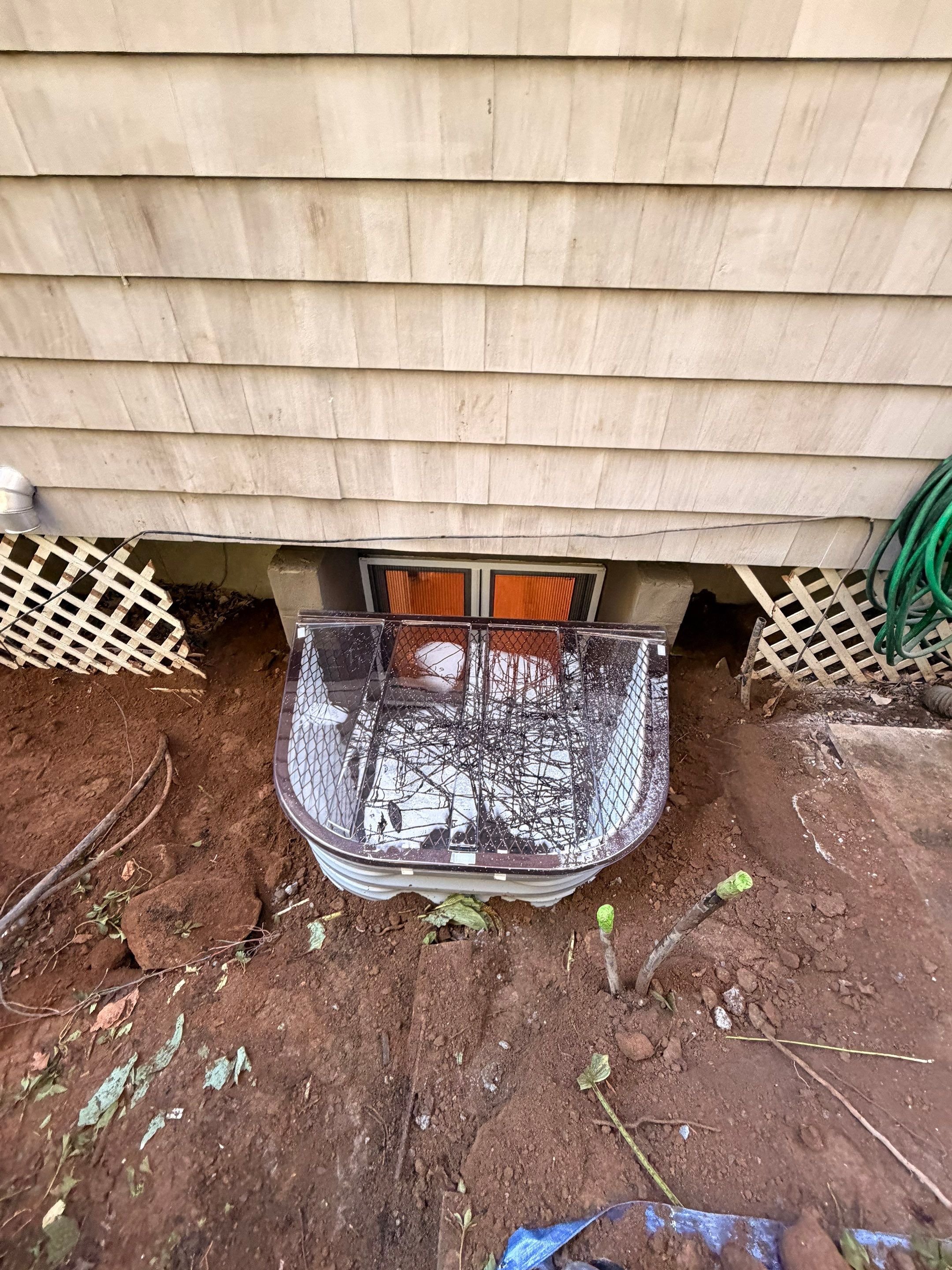 After egress window installation in New Canaan, Connecticut — exterior view