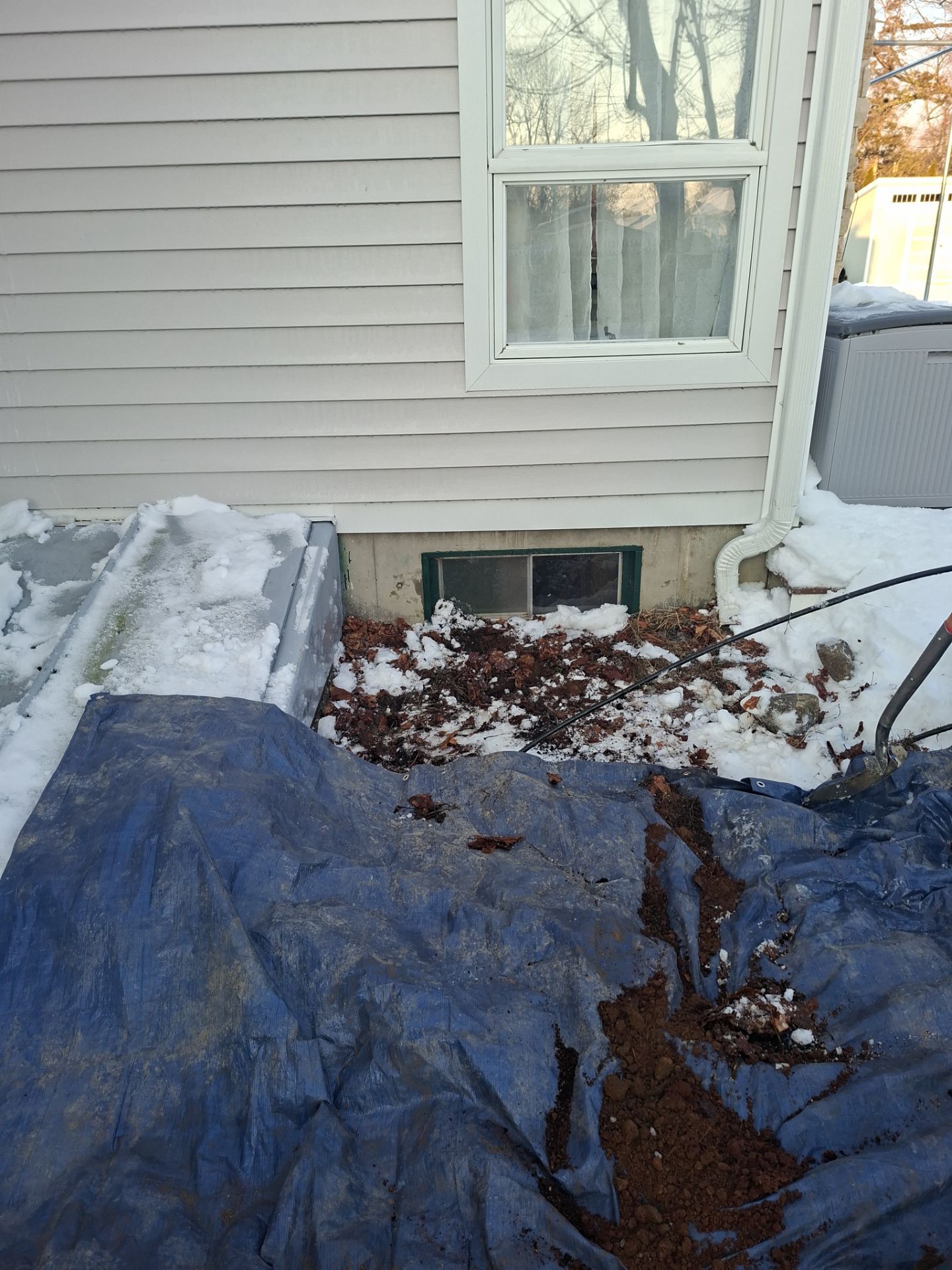 Before egress window installation in Madison, Connecticut — exterior view