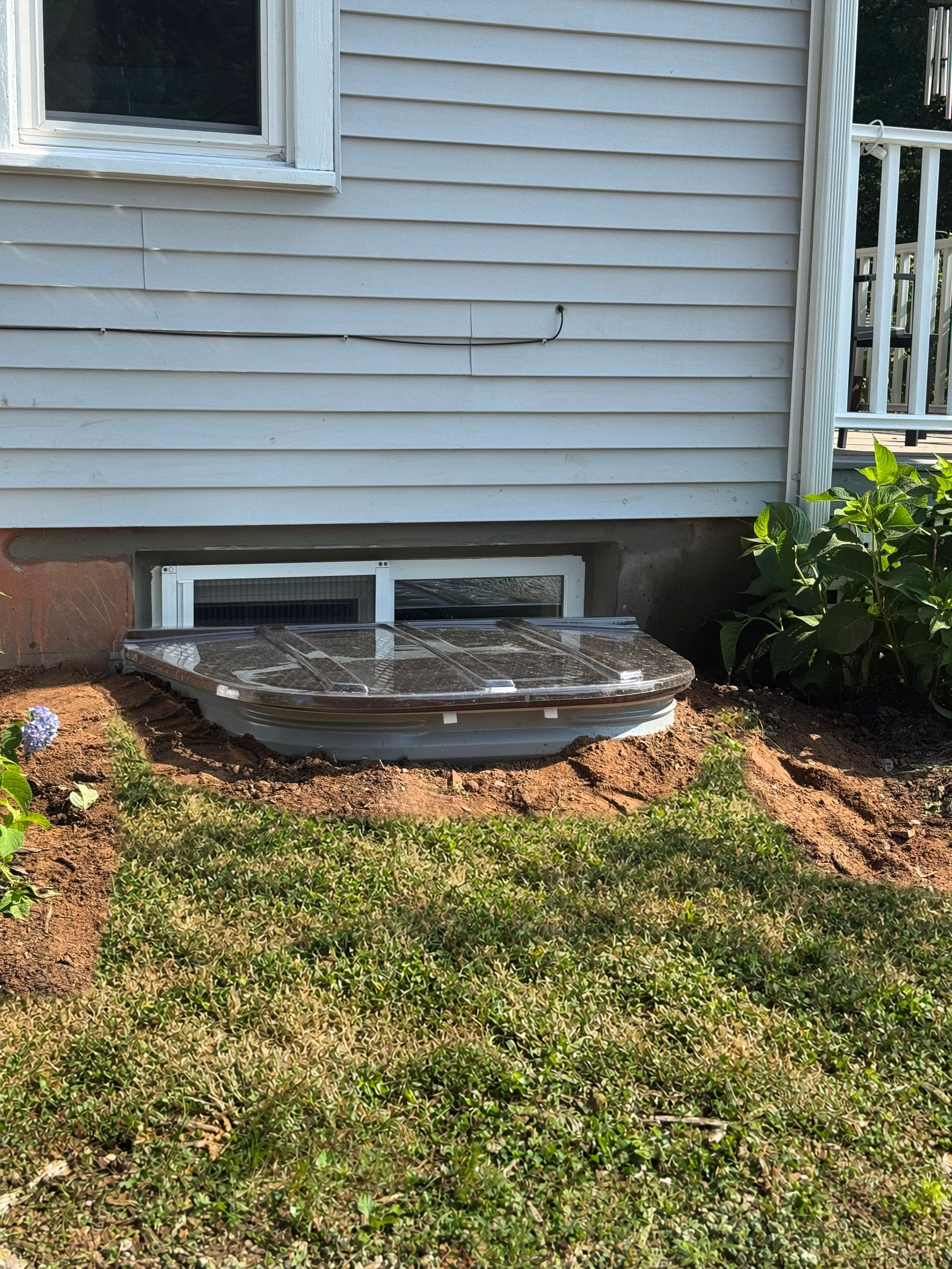After egress window installation in Glastonbury, Connecticut — exterior view